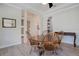 Bright dining room featuring hardwood floors, white trim, columns, arched doorway and traditional wood furniture at 4742 Balboa Park Loop, Bradenton, FL 34211