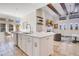Modern kitchen with stainless steel appliances, a center island, and an open layout with connecting living room at 4742 Balboa Park Loop, Bradenton, FL 34211