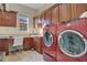Well organized laundry room with sink, desk space and full-sized washer and dryer at 4742 Balboa Park Loop, Bradenton, FL 34211