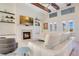 Bright and airy living room featuring a fireplace, high ceilings with wood beams and wall mounted television at 4742 Balboa Park Loop, Bradenton, FL 34211