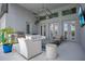 Covered outdoor living area with modern lighting, stainless steel grill, comfortable seating, and a mounted television at 4742 Balboa Park Loop, Bradenton, FL 34211