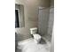 Bathroom with a toilet, walk-in shower and marble tile floors at 4802 51St W St # 1406, Bradenton, FL 34210