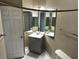 Bathroom showcasing a white door, vanity with a mirror, and a toilet at 4802 51St W St # 1406, Bradenton, FL 34210
