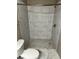 Bathroom featuring a toilet and walk-in shower with white marble tile at 4802 51St W St # 1406, Bradenton, FL 34210
