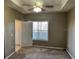 Bedroom features a tray ceiling with fan and a window at 4802 51St W St # 1406, Bradenton, FL 34210
