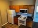 This kitchen features wooden cabinets, black counters, and white appliances, offering a cozy cooking space at 4802 51St W St # 1406, Bradenton, FL 34210