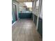 The screened patio has a wood-look floor, painted railings and door to the left at 4802 51St W St # 1406, Bradenton, FL 34210