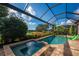 Resort-style pool and spa with screened enclosure, overlooking a lake at 5473 Manchini St, Sarasota, FL 34238