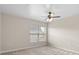 Simple bedroom with large window and ceiling fan at 5560 Rosehill Rd # 201, Sarasota, FL 34233
