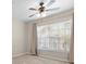 Bedroom with large window, ceiling fan and neutral decor at 5560 Rosehill Rd # 201, Sarasota, FL 34233
