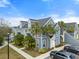 Two-story building with gray siding, palm trees, and parking at 5560 Rosehill Rd # 201, Sarasota, FL 34233
