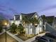 Two-story townhome with gray siding, white trim, and palm trees at 5560 Rosehill Rd # 201, Sarasota, FL 34233