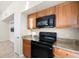 Modern kitchen with granite countertops and wood cabinets at 5560 Rosehill Rd # 201, Sarasota, FL 34233