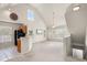 Open living area with high ceilings, kitchen island and stairs at 5560 Rosehill Rd # 201, Sarasota, FL 34233