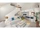 Open living room with vaulted ceilings, neutral color palette, and a breakfast bar at 5560 Rosehill Rd # 201, Sarasota, FL 34233