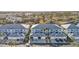Aerial view of the condo complex showcasing garages, palm trees, and well-maintained landscaping at 5763 Sabal Trace Dr # 202 Bd5763, North Port, FL 34287