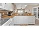 Open-concept kitchen with sleek white cabinets, tiled backsplash, and stainless steel appliances at 5763 Sabal Trace Dr # 202 Bd5763, North Port, FL 34287