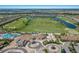 Aerial view of community with golf course and clubhouse at 5830 Wake Forest Run # 102, Bradenton, FL 34211