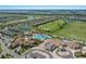 Aerial view of community with pool, clubhouse, and golf course at 5830 Wake Forest Run # 102, Bradenton, FL 34211