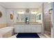 Elegant bathroom with double vanity, soaking tub, and walk-in shower at 5830 Wake Forest Run # 102, Bradenton, FL 34211