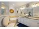 Spa-like bathroom featuring a double vanity and a relaxing soaking tub at 5830 Wake Forest Run # 102, Bradenton, FL 34211