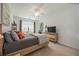 Bright bedroom with a queen bed, TV, and a window with blinds at 5830 Wake Forest Run # 102, Bradenton, FL 34211