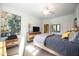 Bedroom with a queen bed, dresser, and large art at 5830 Wake Forest Run # 102, Bradenton, FL 34211