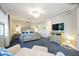 Primary bedroom with king bed, sitting area and TV at 5830 Wake Forest Run # 102, Bradenton, FL 34211