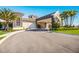 Elegant clubhouse entrance with palm trees and landscaping at 5830 Wake Forest Run # 102, Bradenton, FL 34211