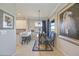 Charming dining area with a glass table and blue patterned chairs at 5830 Wake Forest Run # 102, Bradenton, FL 34211