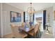Elegant dining room with a large wooden table and chandelier at 5830 Wake Forest Run # 102, Bradenton, FL 34211