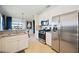 Modern kitchen featuring stainless steel appliances and white cabinetry at 5830 Wake Forest Run # 102, Bradenton, FL 34211