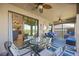 Relaxing lanai with glass-top table and comfortable seating, overlooking the golf course at 5830 Wake Forest Run # 102, Bradenton, FL 34211