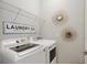 Convenient laundry room with washer, dryer, and shelving at 5830 Wake Forest Run # 102, Bradenton, FL 34211