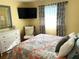 Bedroom with a comfortable bed and corner TV at 5973 Terrace Park N Dr # 208, St Petersburg, FL 33709