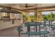 Outdoor kitchen with grill, tables, and seating at 5973 Terrace Park N Dr # 208, St Petersburg, FL 33709