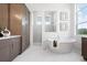 Bright bathroom with freestanding tub, separate shower, and elegant vanity with storage at 624 Blue Shell Loop, Sarasota, FL 34240