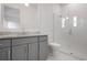 Modern bathroom featuring a glass-enclosed shower, and sleek gray vanity at 624 Blue Shell Loop, Sarasota, FL 34240