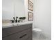 Elegant bathroom with a granite countertop, black fixtures, and decorative artwork at 624 Blue Shell Loop, Sarasota, FL 34240