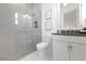 Modern bathroom featuring a glass shower with mosaic tile and gray countertops at 624 Blue Shell Loop, Sarasota, FL 34240