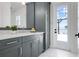 Modern bathroom featuring gray cabinets, marble countertops, and a view of the water at 624 Blue Shell Loop, Sarasota, FL 34240