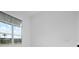 Bright bedroom featuring a large window with blinds and neutral-colored walls at 624 Blue Shell Loop, Sarasota, FL 34240