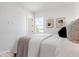 Tranquil bedroom with a comfortable bed, modern art, and bright natural light at 624 Blue Shell Loop, Sarasota, FL 34240