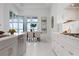Bright dining area with view to water, modern decor and a stylish dining table at 624 Blue Shell Loop, Sarasota, FL 34240
