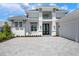 Beautiful house with a three-car garage, a stone paver driveway, and manicured landscaping at 624 Blue Shell Loop, Sarasota, FL 34240