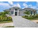 Stunning two-story home with a three-car garage, lush landscaping, and stone accents at 624 Blue Shell Loop, Sarasota, FL 34240
