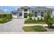 Beautiful two-story home with lush landscaping, a tiled roof, and a brick driveway at 624 Blue Shell Loop, Sarasota, FL 34240