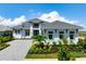 Beautiful two-story home with manicured landscaping and a paver driveway at 624 Blue Shell Loop, Sarasota, FL 34240