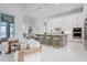 Modern kitchen with stainless steel appliances, a large island, and seating, open to the living area at 624 Blue Shell Loop, Sarasota, FL 34240