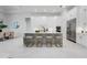Spacious white kitchen with a large island, modern appliances, and adjacent dining area at 624 Blue Shell Loop, Sarasota, FL 34240